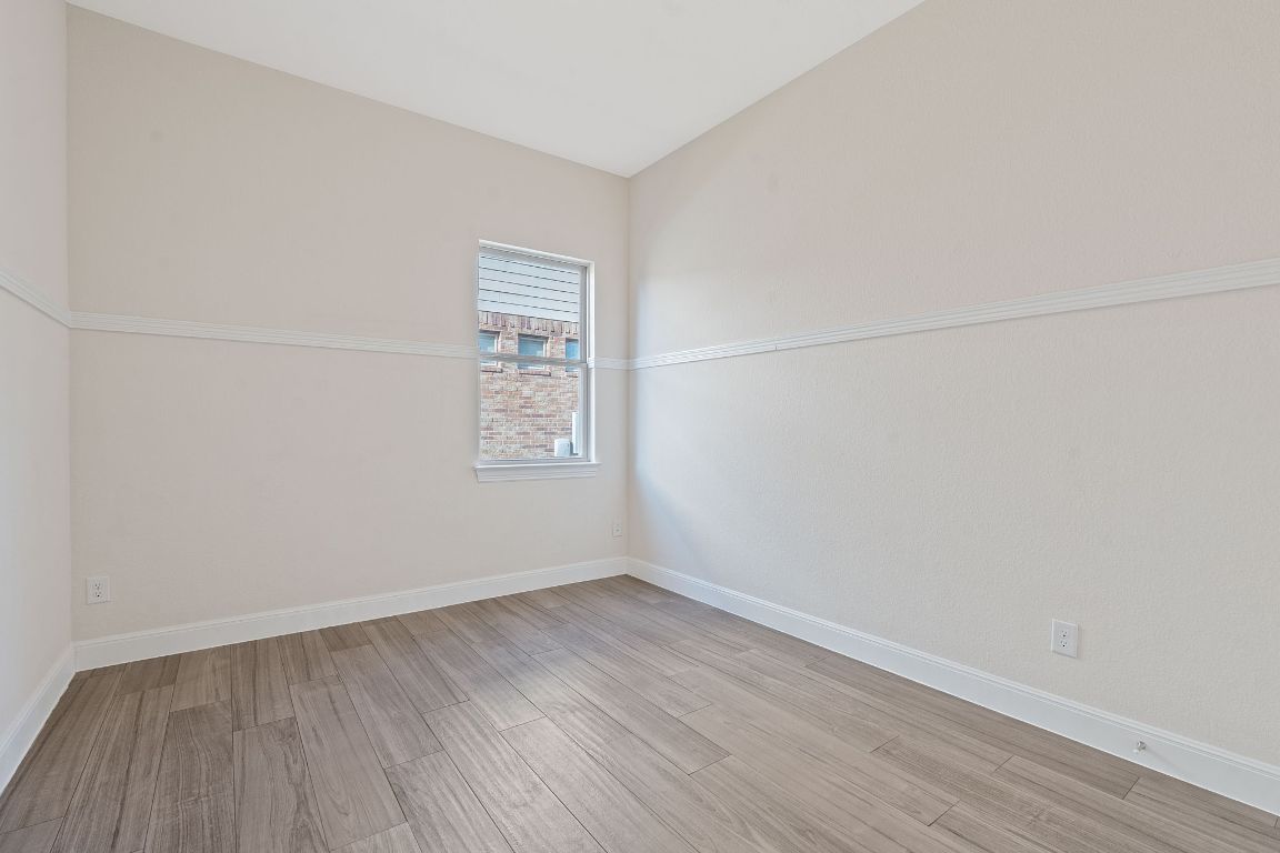 21100 Windmill Ranch Avenue Pflugerville, TX 78660 - Photo 15 of 29 a view of a room that has wooden floor in it