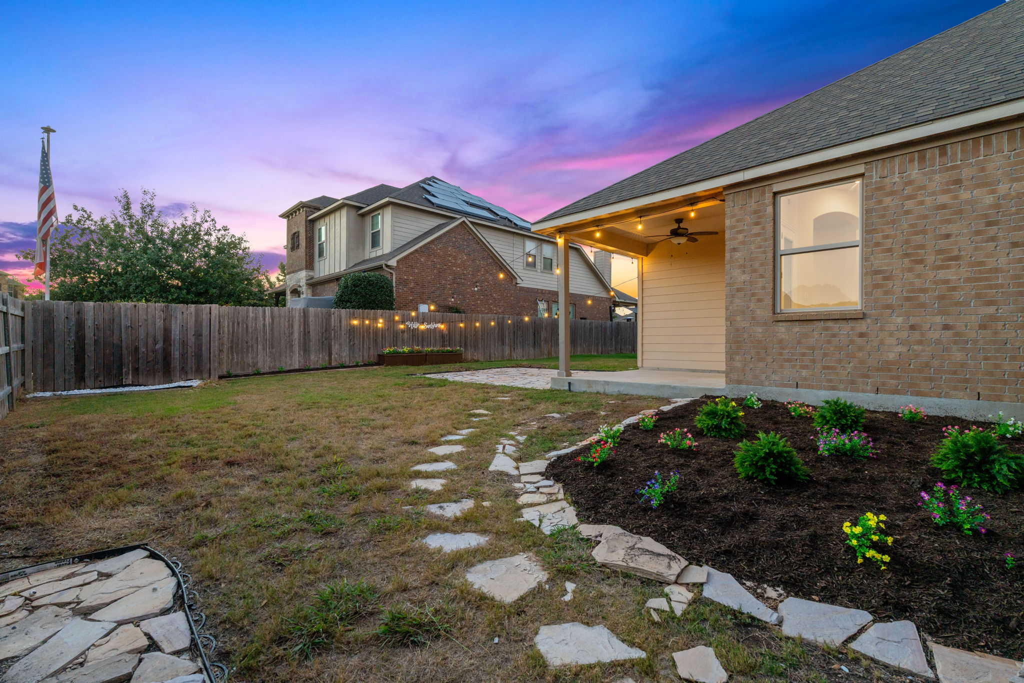 21100 Windmill Ranch Avenue Pflugerville, TX 78660 - Photo 21 of 29 Yard at dusk with ceiling fan, a patio, and a fenced backyard