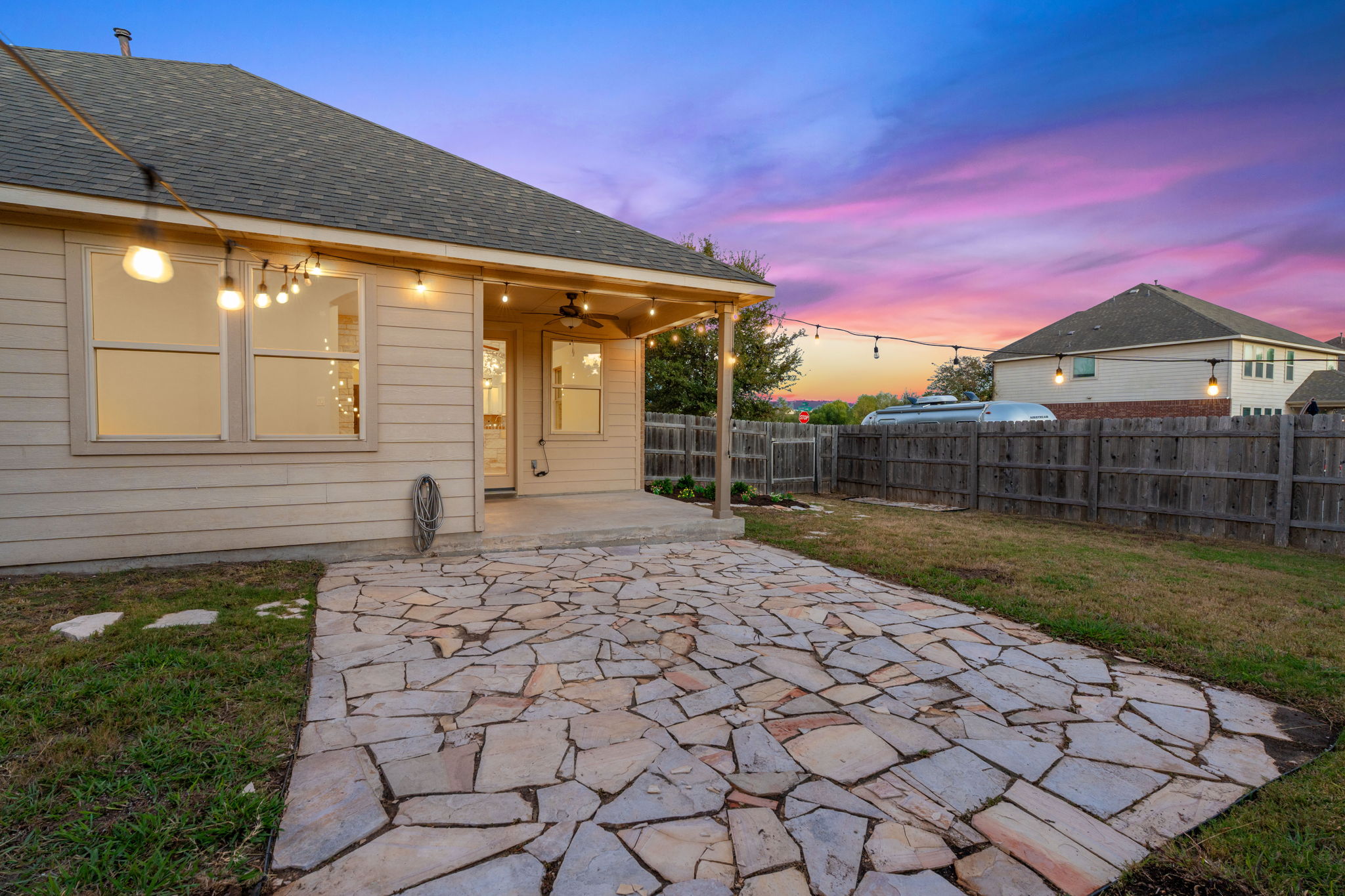 21100 Windmill Ranch Avenue Pflugerville, TX 78660 - Photo 23 of 29 Patio terrace at dusk featuring a patio, a fenced backyard, and ceiling fan