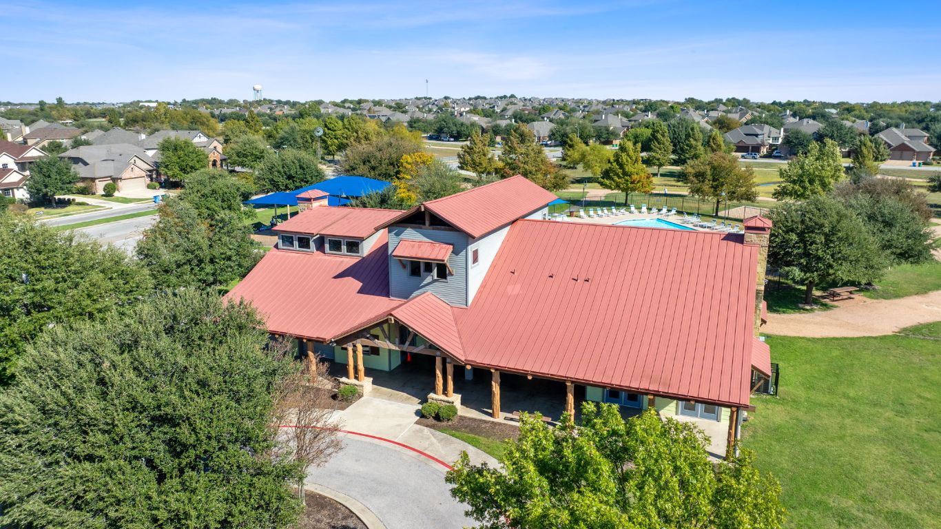 21100 Windmill Ranch Avenue Pflugerville, TX 78660 - Photo 25 of 29 an aerial view of a house with a garden and lake view