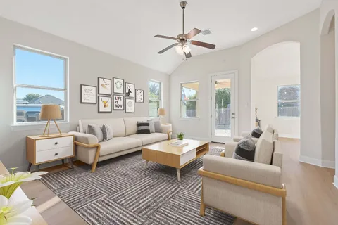 a living room with furniture and a large window