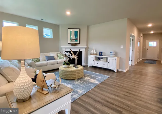 a kitchen with stainless steel appliances a dining table chairs refrigerator and microwave