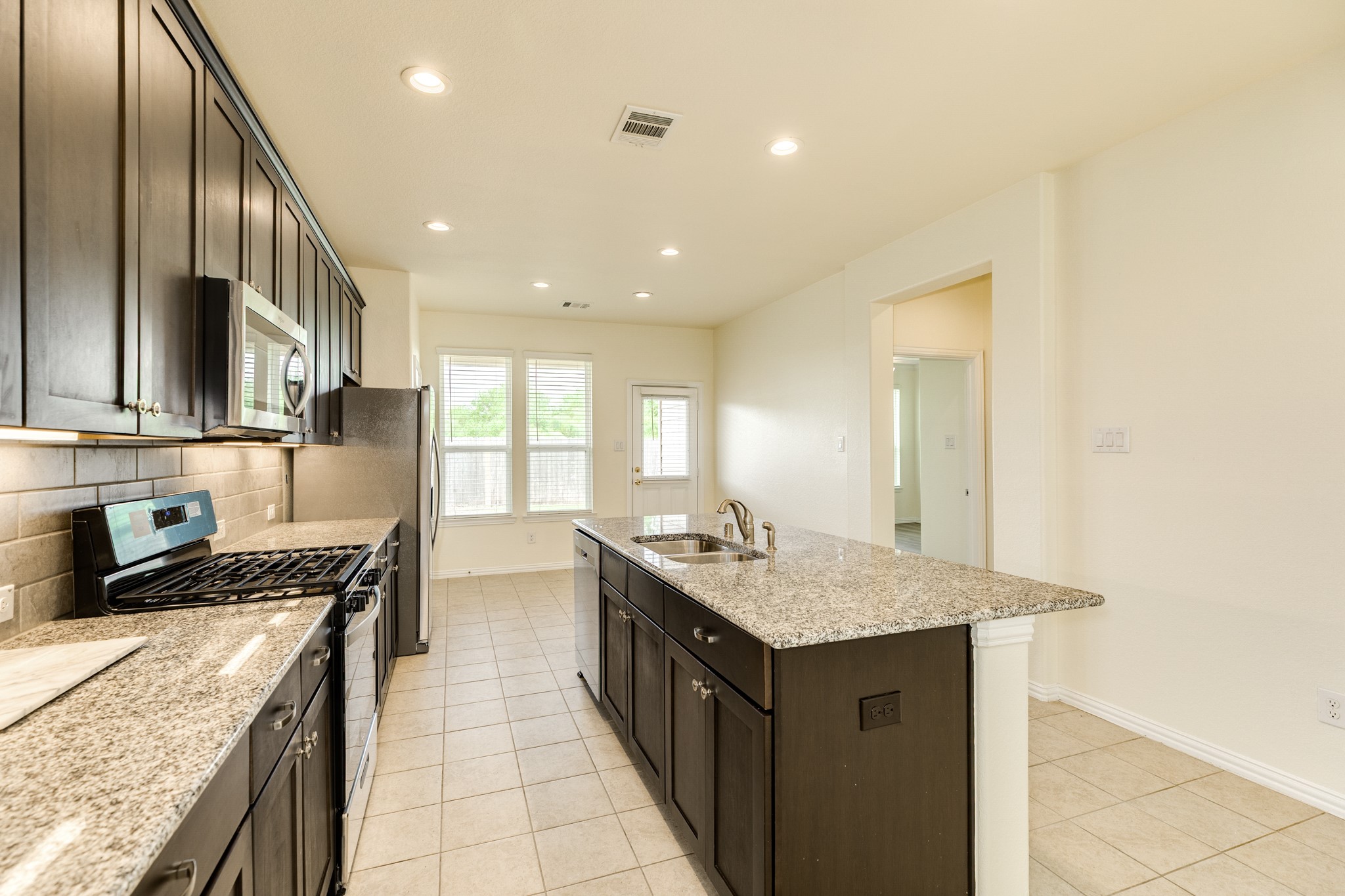 1301 Scarlet Mountain Drive Rosharon, TX 77583 - Photo 10 of 43 a kitchen with a stove and a sink
