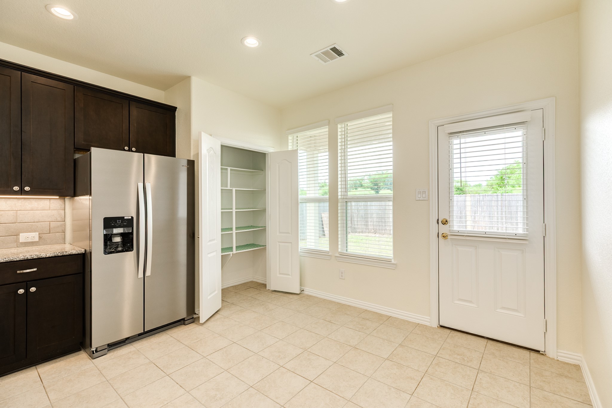 1301 Scarlet Mountain Drive Rosharon, TX 77583 - Photo 11 of 43 a kitchen with stainless steel appliances a refrigerator and a stove top oven