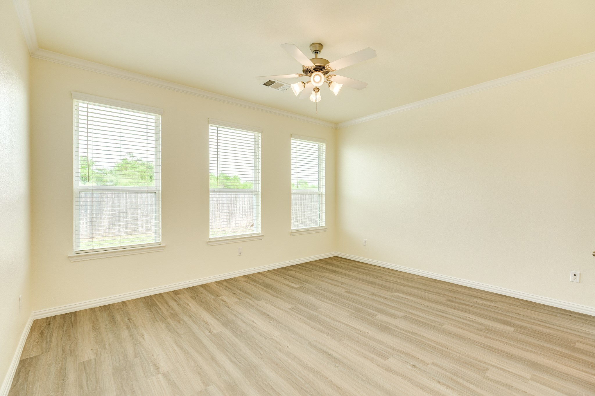 1301 Scarlet Mountain Drive Rosharon, TX 77583 - Photo 12 of 43 a view of an empty room with wooden floor and a window