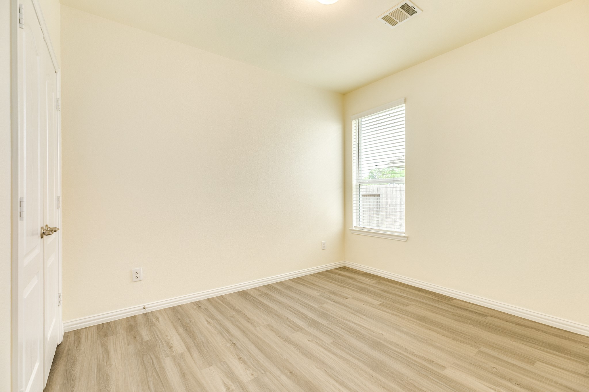 1301 Scarlet Mountain Drive Rosharon, TX 77583 - Photo 17 of 43 a view of an empty room with wooden floor and a window