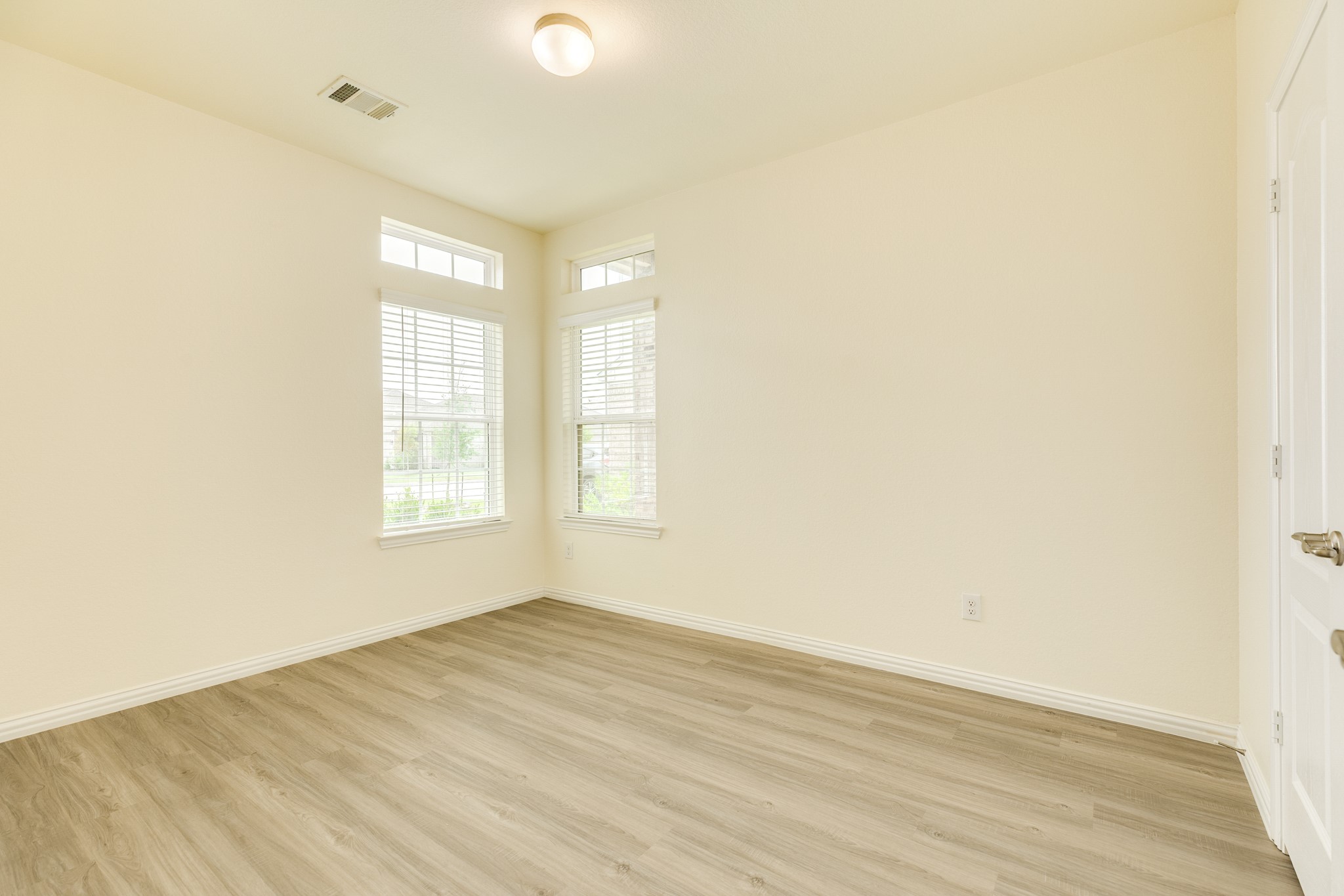 1301 Scarlet Mountain Drive Rosharon, TX 77583 - Photo 18 of 43 an empty room with wooden floor and windows