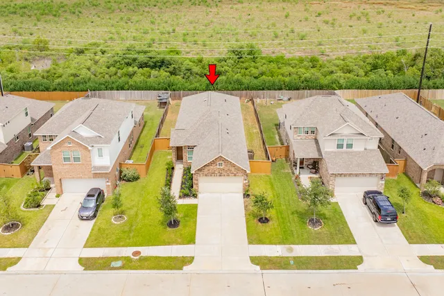 an aerial view of a house with a garden and swimming pool