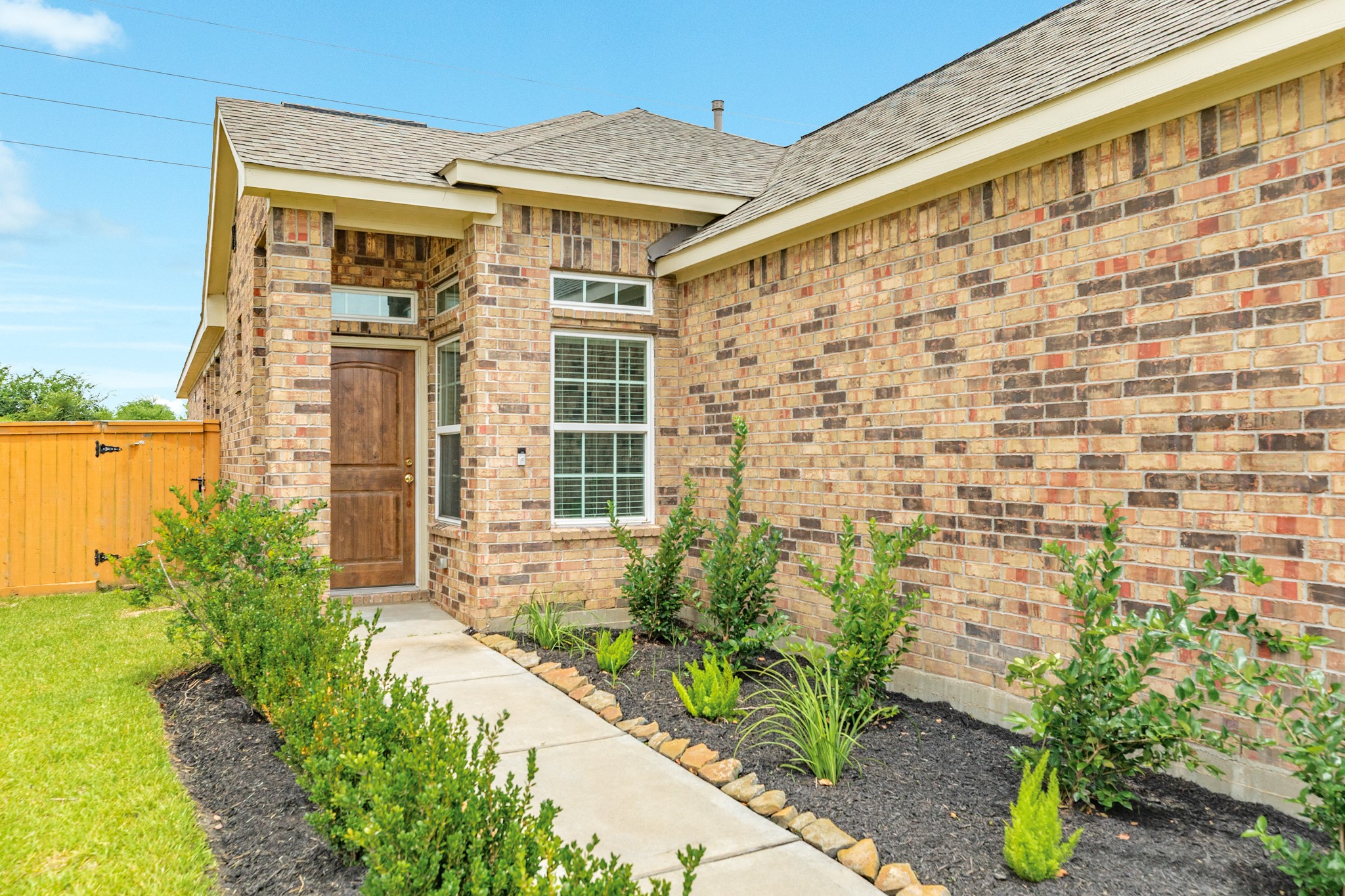 1301 Scarlet Mountain Drive Rosharon, TX 77583 - Photo 33 of 43 a front view of a house with a garden