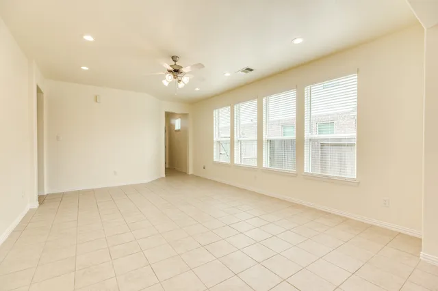 wooden floor in an empty room with a ceiling fan