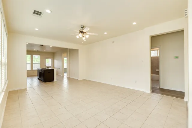 a view of an empty room with a kitchen