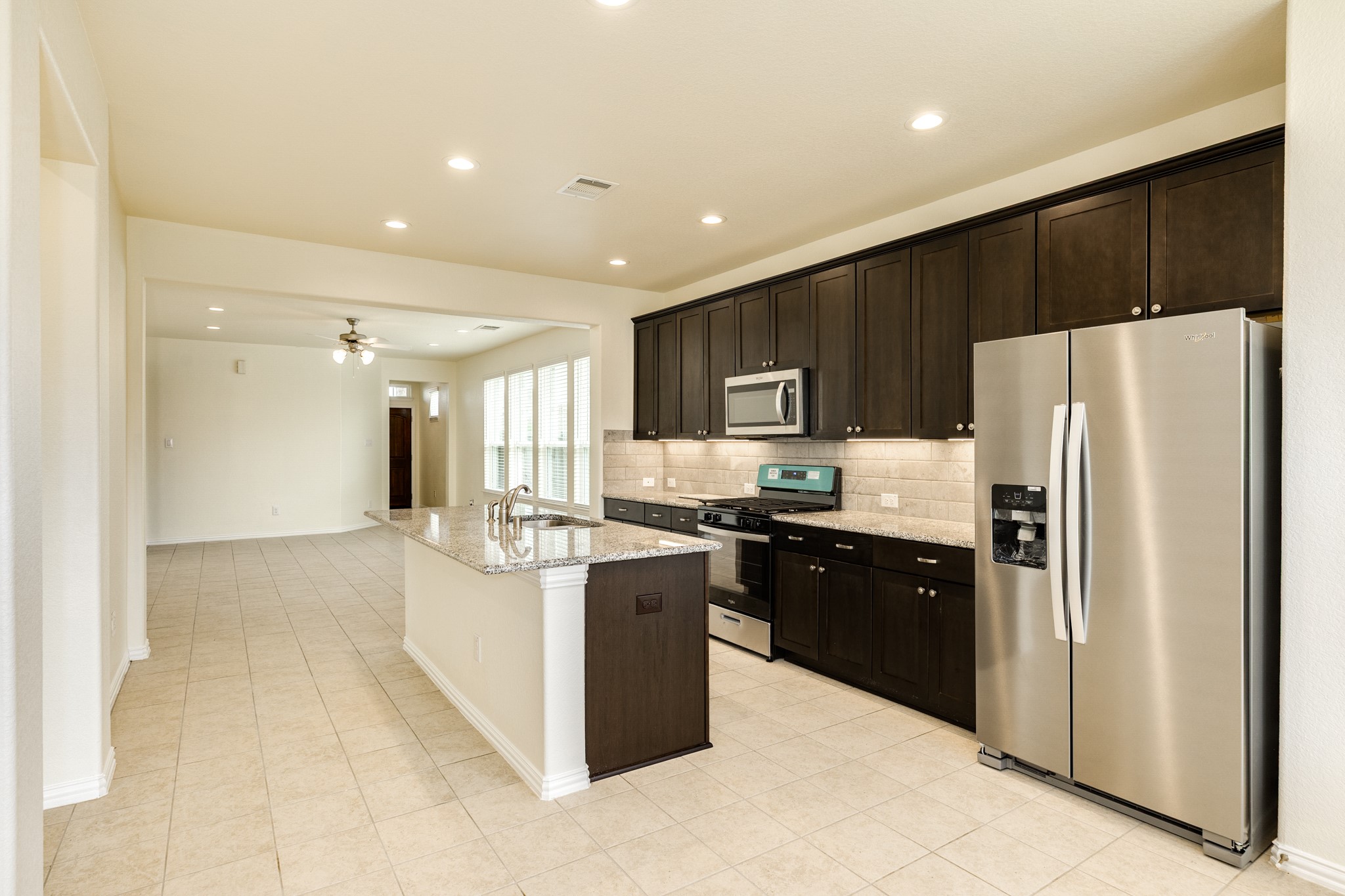 1301 Scarlet Mountain Drive Rosharon, TX 77583 - Photo 9 of 43 a kitchen with stainless steel appliances granite countertop a refrigerator and a stove