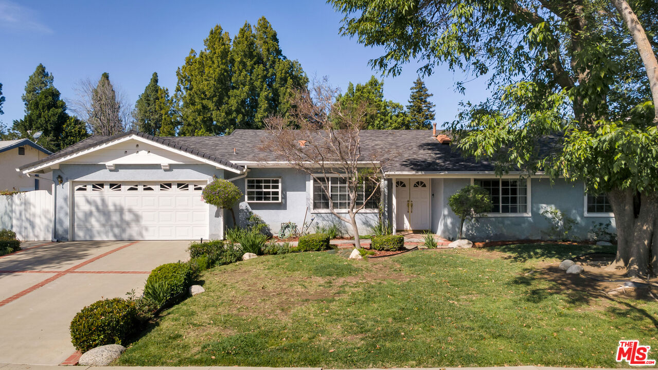 a front view of a house with garden and patio