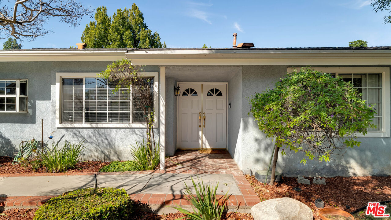 18501 Germain Street Porter Ranch, CA 91326 - Photo 2 of 55 a front view of a house with a yard