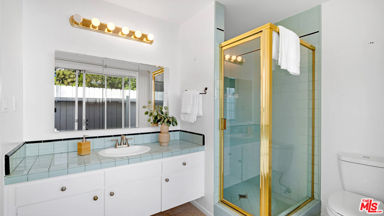 18501 Germain Street Porter Ranch, CA 91326 - Photo 31 of 55 a bathroom with a granite countertop sink and a mirror