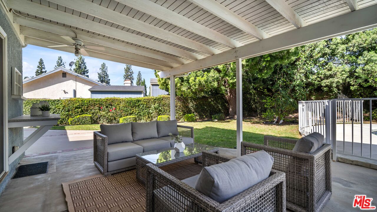 18501 Germain Street Porter Ranch, CA 91326 - Photo 34 of 55 a view of a patio with couches chairs and a backyard