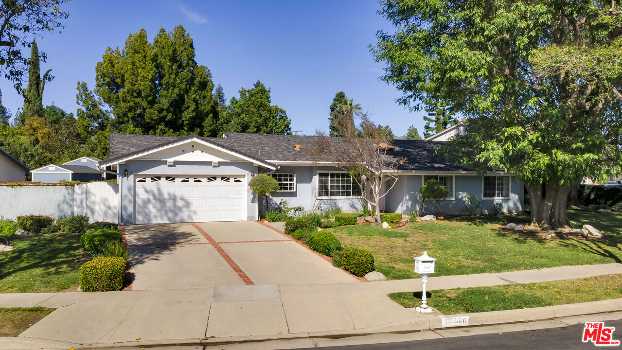 18501 Germain Street Porter Ranch, CA 91326 - Photo 48 of 55 a front view of a house with a yard