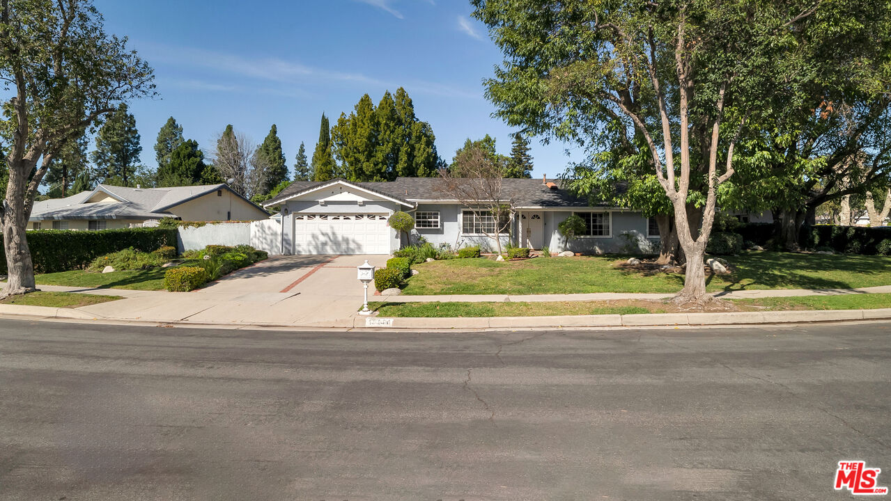 18501 Germain Street Porter Ranch, CA 91326 - Photo 49 of 55 a view of a house with a garden and trees