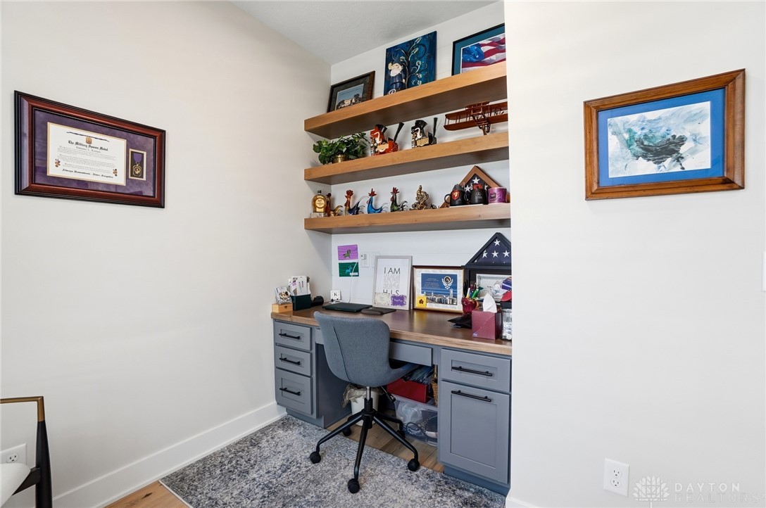 1247 Normandy Rue Dayton, OH 45458 - Photo 36 of 76 This dedicated workspace offers built-in shelving, providing a functional and organized environment.