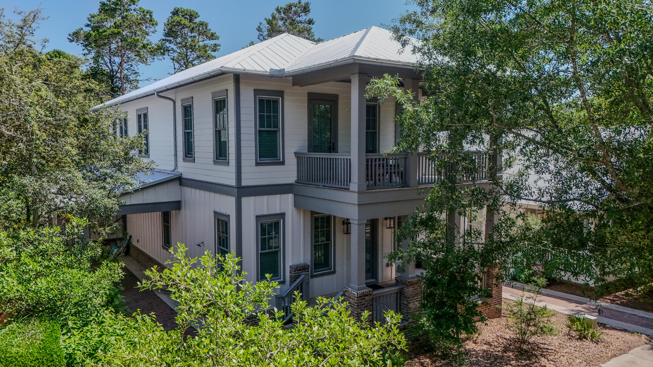 51 Okeechobee West Santa Rosa Beach, FL 32459 - Photo 2 of 78 a view of a white house with large windows and a small yard
