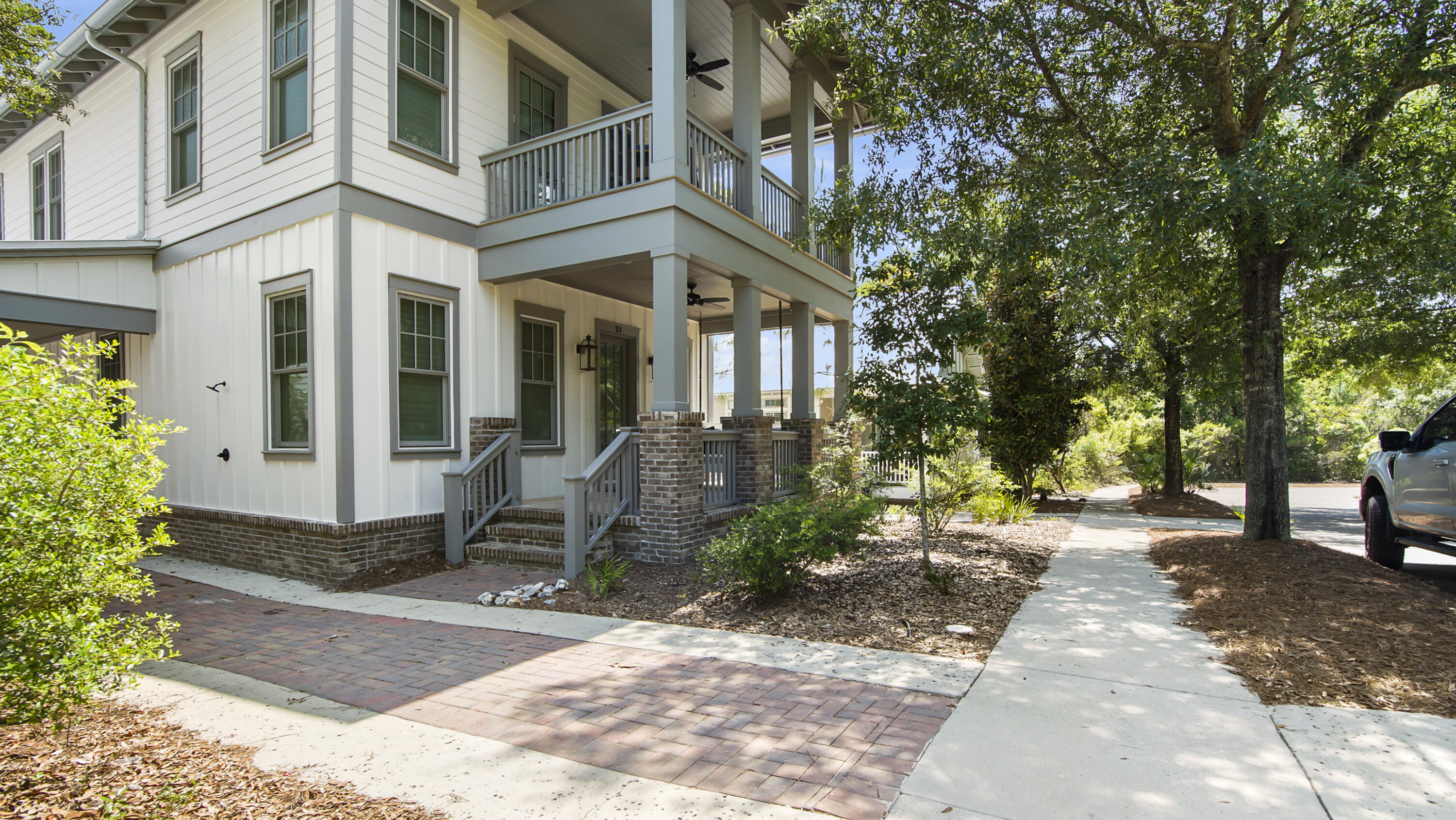 51 Okeechobee West Santa Rosa Beach, FL 32459 - Photo 64 of 78 a view of a brick house with many windows next to a yard