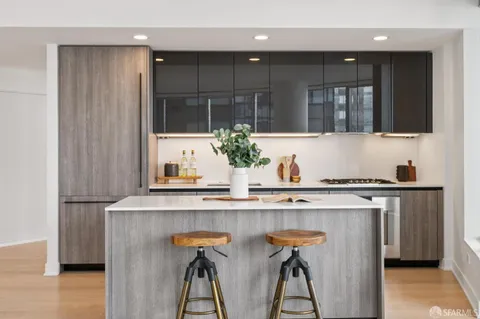 a kitchen with stainless steel appliances kitchen island granite countertop a sink and cabinets