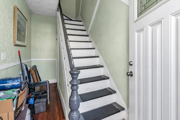 a view of entryway with wooden floor and stairs