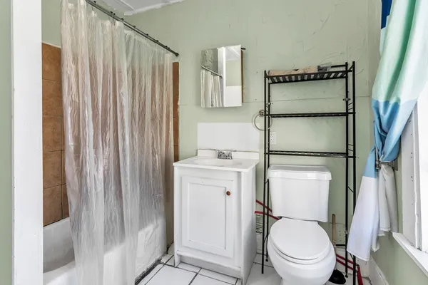 a white toilet sitting next to a bathroom sink