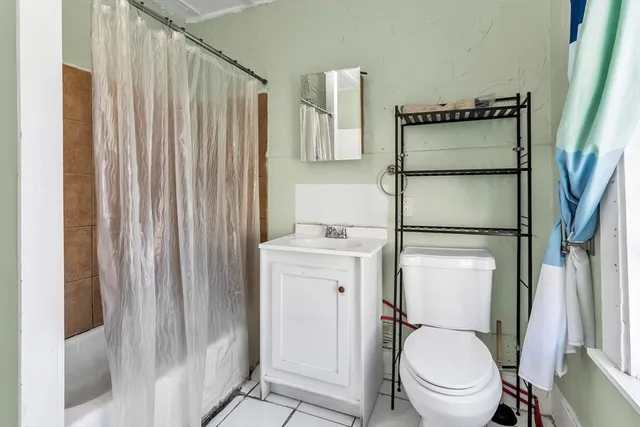 a white toilet sitting next to a bathroom sink