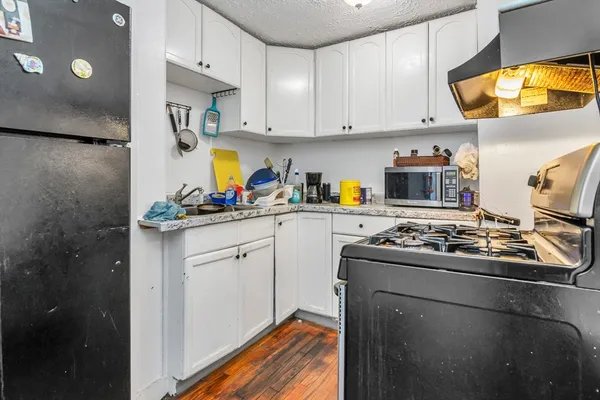 a kitchen with stainless steel appliances granite countertop a stove a sink dishwasher and a refrigerator