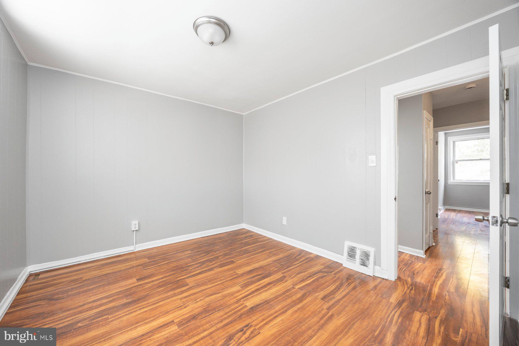 504 Roundview Road Baltimore, MD 21225 - Photo 16 of 26 a view of empty room with wooden floor