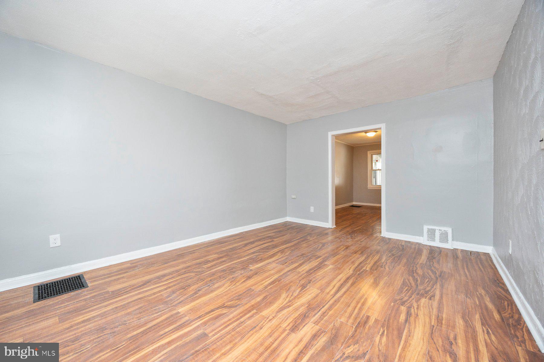 504 Roundview Road Baltimore, MD 21225 - Photo 8 of 26 a view of empty room with wooden floor