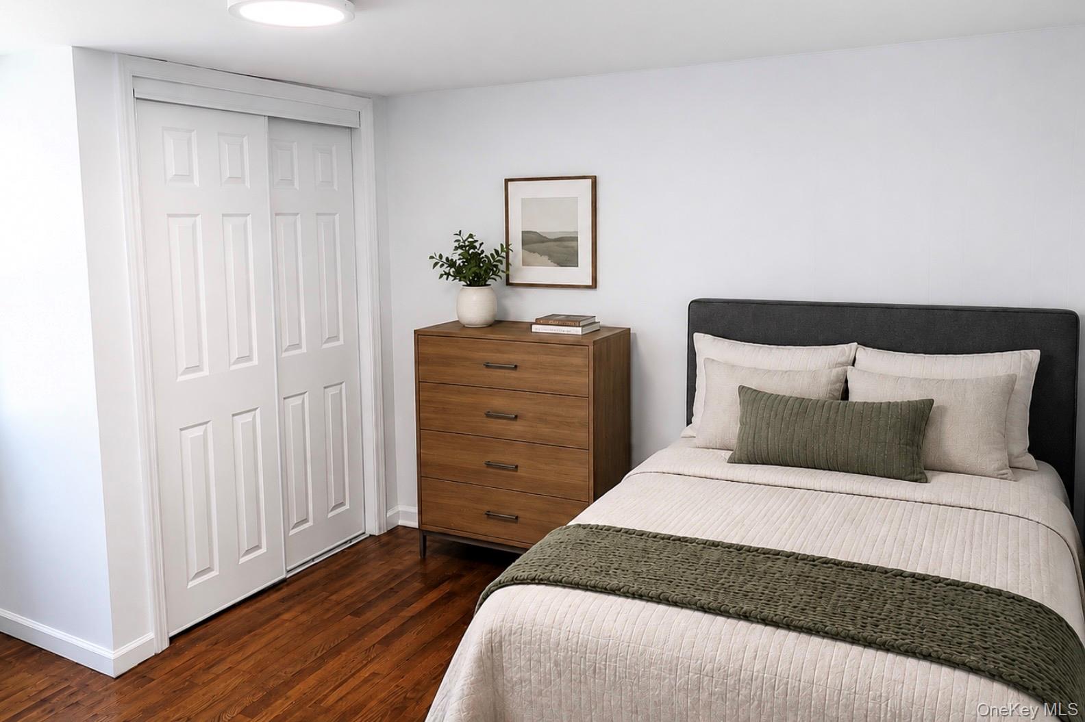 80 Mt Pleasant Road Smithtown, NY 11787 - Photo 16 of 27 a bedroom with a bed and a dresser