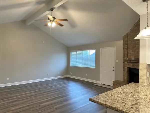 a kitchen with kitchen island a sink dishwasher a stove and a wooden floor