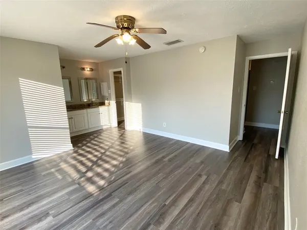 a view of a kitchen with wooden floor and a kitchen space