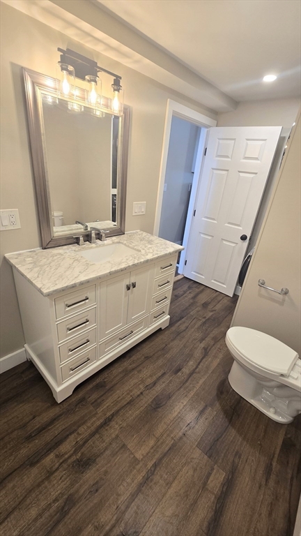 15 Central Street, Unit 4 Georgetown, MA 01833 - Photo 11 of 24 a bathroom with a sink mirror vanity and toilet