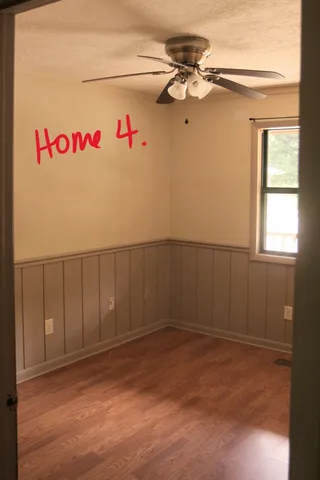 a bedroom with furniture and a wooden floor
