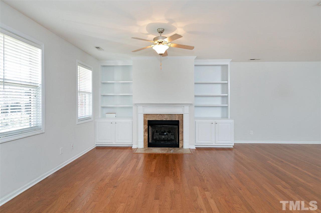 1340 Regulator Street Raleigh, NC 27603 - Photo 3 of 30 wooden floor fireplace and windows in an empty room