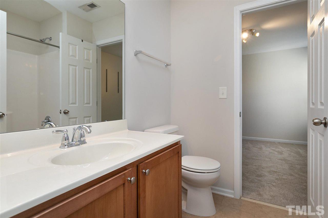 1340 Regulator Street Raleigh, NC 27603 - Photo 23 of 30 a bathroom with a sink a toilet and shower