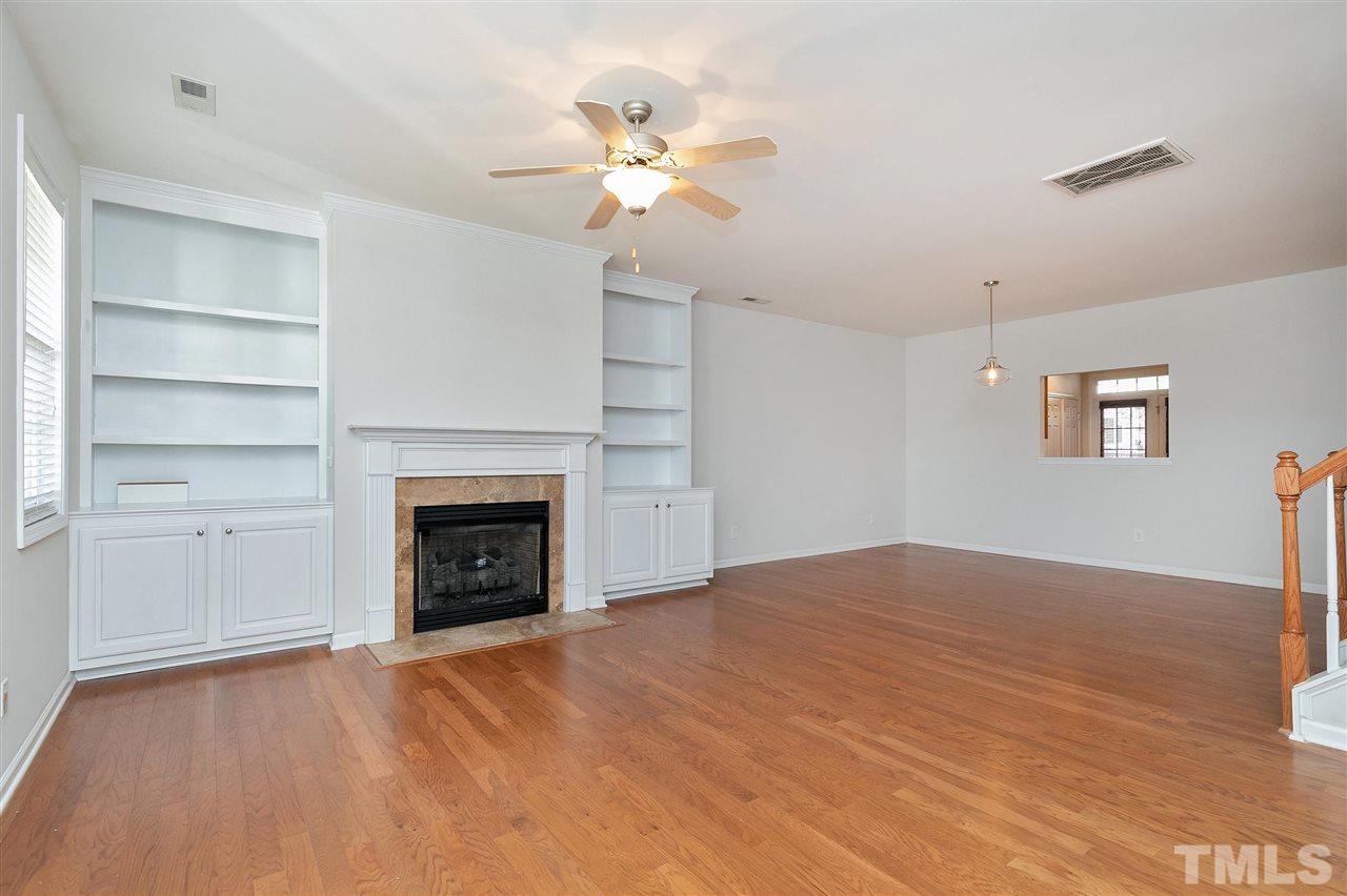 1340 Regulator Street Raleigh, NC 27603 - Photo 4 of 30 a view of empty room with a fireplace and wooden floor