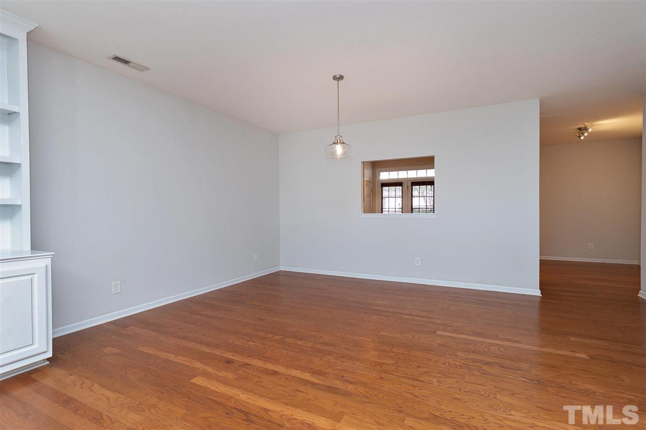1340 Regulator Street Raleigh, NC 27603 - Photo 5 of 30 a view of an empty room with wooden floor and a window