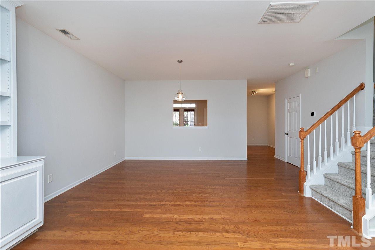 1340 Regulator Street Raleigh, NC 27603 - Photo 6 of 30 a view of an empty room with wooden floor and a window