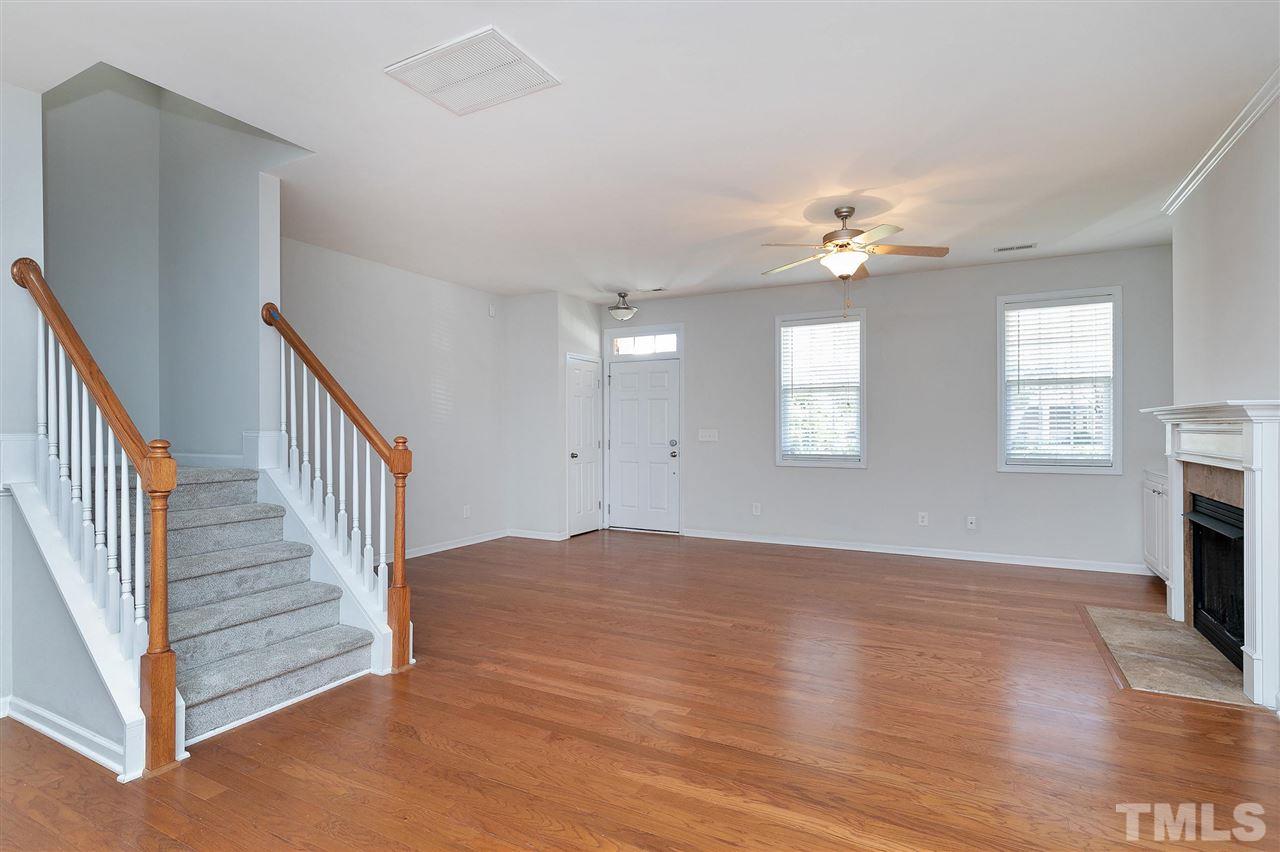1340 Regulator Street Raleigh, NC 27603 - Photo 7 of 30 a view of an empty room with a window and wooden floor