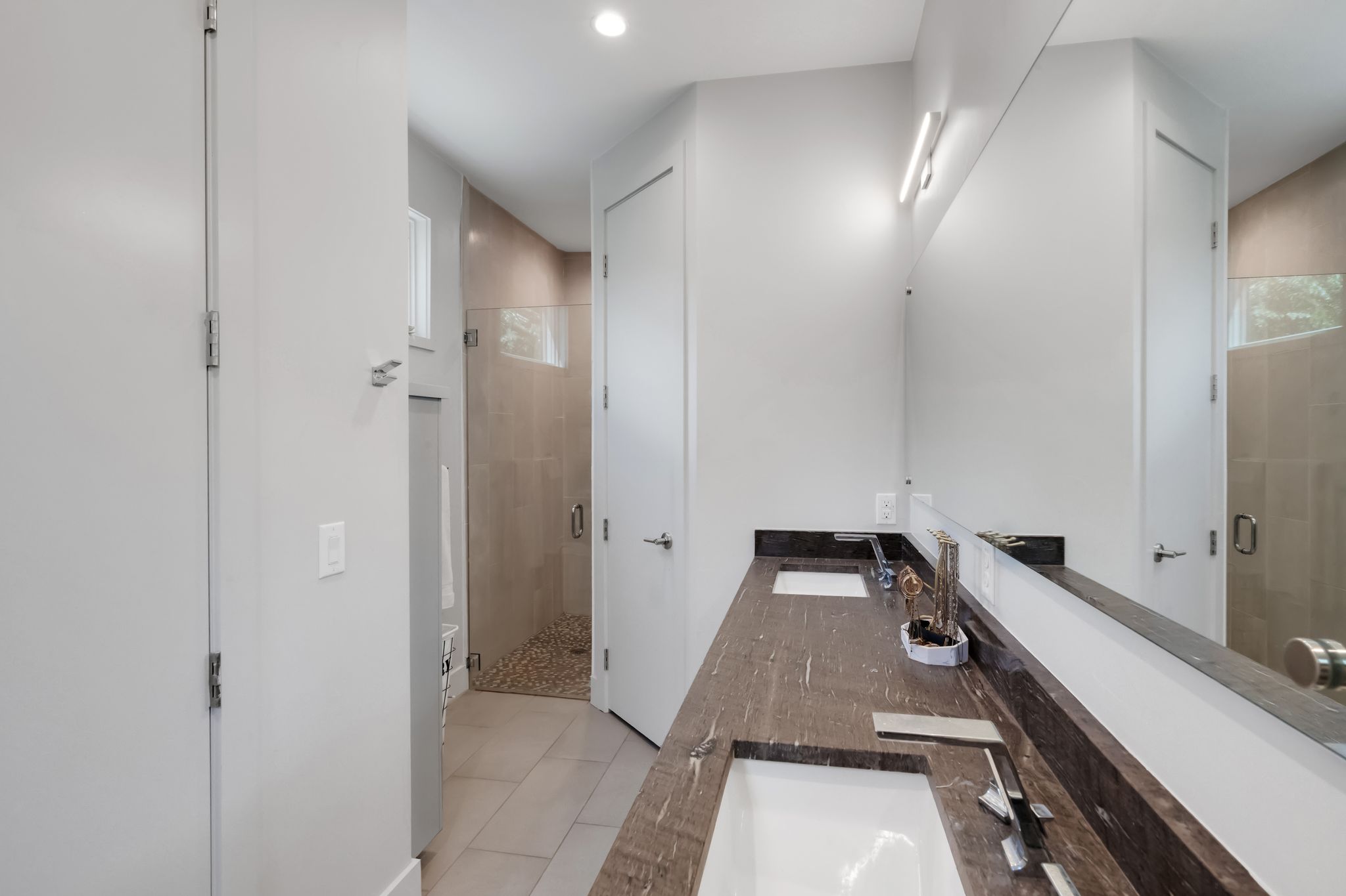 809 Bouldin Avenue Austin, TX 78704 - Photo 34 of 39 Bathroom with double vanity, a stall shower, light tile patterned floors, and recessed lighting
