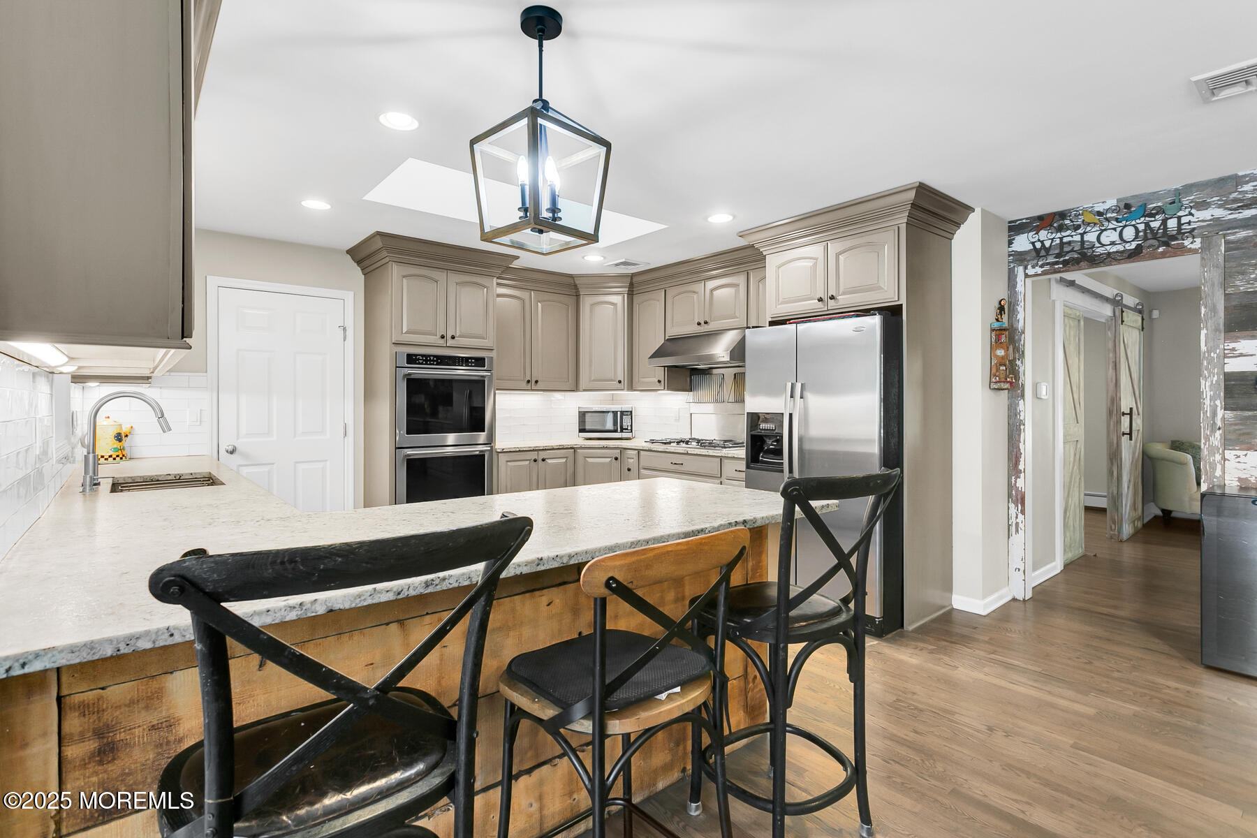 28 Colonial Terrace Colts Neck, NJ 07722 - Photo 18 of 57 a kitchen with stainless steel appliances kitchen island granite countertop a refrigerator and microwave
