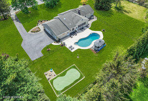 28 Colonial Terrace Colts Neck, NJ 07722 - Photo 2 of 57 an aerial view of a house with a garden and trees