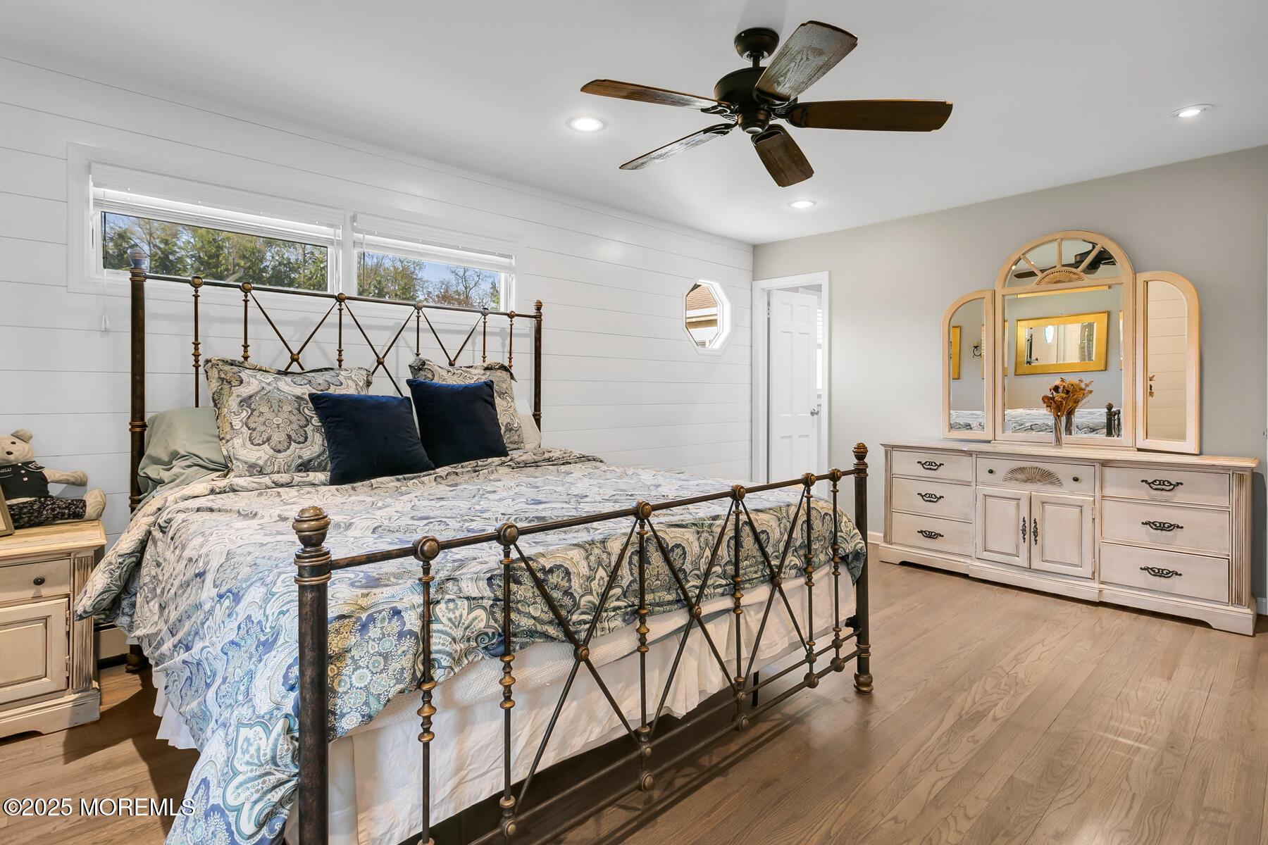 28 Colonial Terrace Colts Neck, NJ 07722 - Photo 22 of 57 a bedroom with a bed a chandelier and dresser