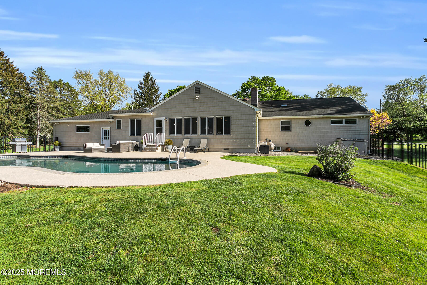 28 Colonial Terrace Colts Neck, NJ 07722 - Photo 4 of 57 a front view of a house with garden house and swimming pool
