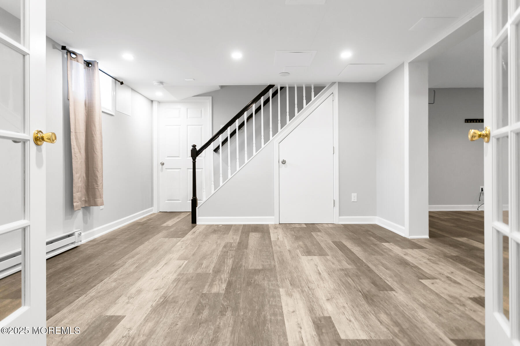 28 Colonial Terrace Colts Neck, NJ 07722 - Photo 39 of 57 a view of a hallway with wooden floor and staircase