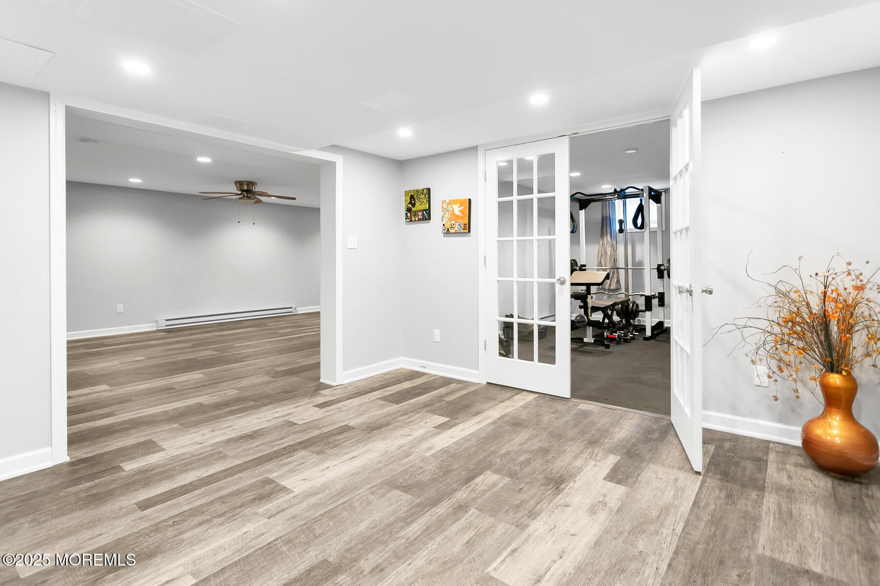 28 Colonial Terrace Colts Neck, NJ 07722 - Photo 40 of 57 a view of a hallway with wooden floor and a living room